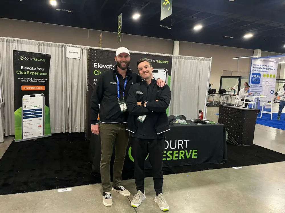 Kyle with a colleague at the CourtReserve booth on a trade show floor