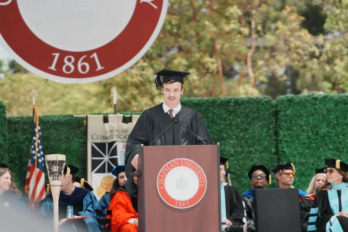 Kyle delivering a commencement address at a podium