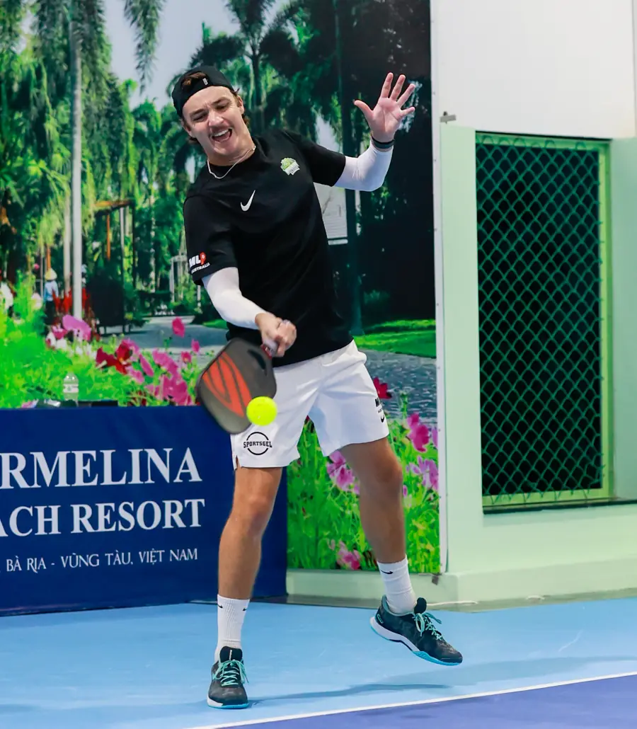 Kyle hitting a forehand during a professional pickleball match